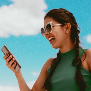 Woman looking at a phone laughing