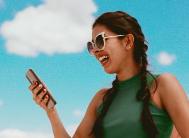 Woman looking at a phone laughing